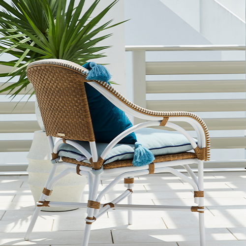 woven lounge chair next to palm tree