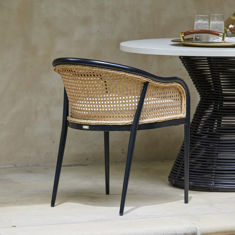 dining chairs next to table with lantern