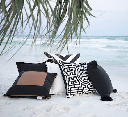 outdoor pillows on the beach with ocean in background
