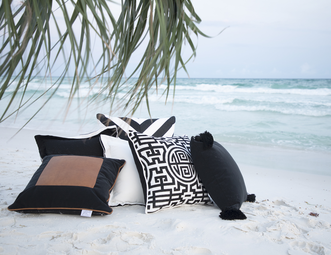 outdoor pillows on the beach with ocean in background